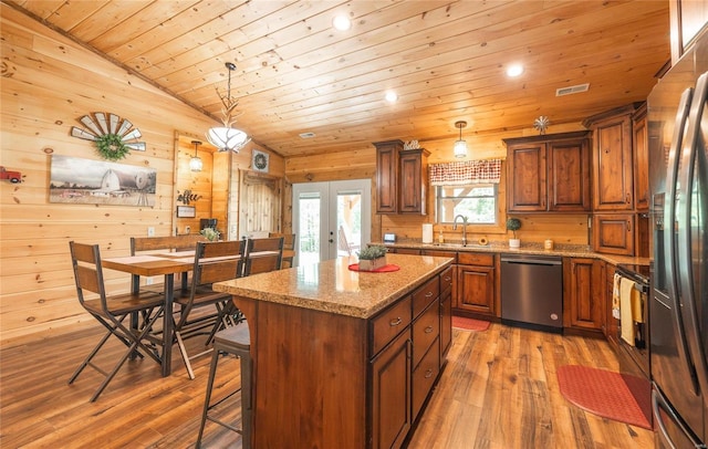 kitchen with french doors, sink, a center island, pendant lighting, and stainless steel appliances