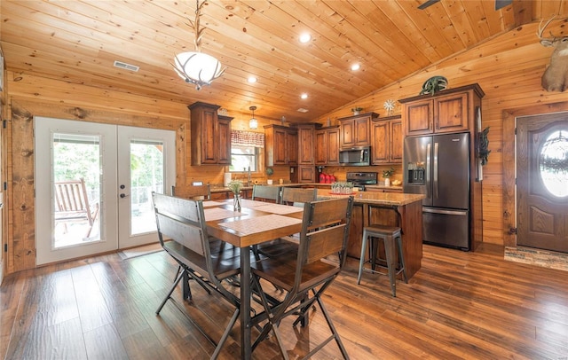 dining area with vaulted ceiling, wood walls, dark hardwood / wood-style flooring, wood ceiling, and french doors