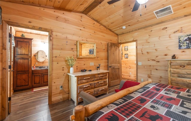 bedroom with wood walls, dark hardwood / wood-style flooring, vaulted ceiling, and wooden ceiling