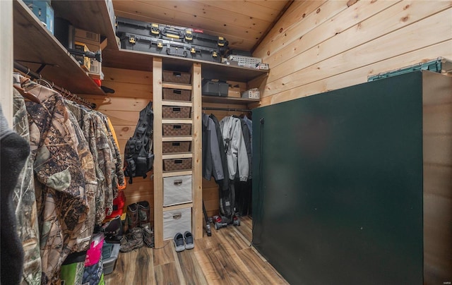 walk in closet featuring hardwood / wood-style flooring and vaulted ceiling