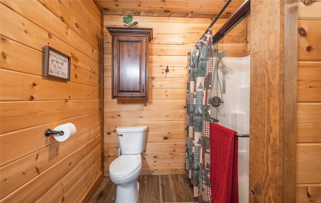 bathroom with walk in shower, wood-type flooring, toilet, and wood walls