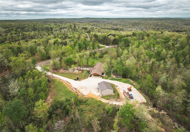 bird's eye view with a wooded view