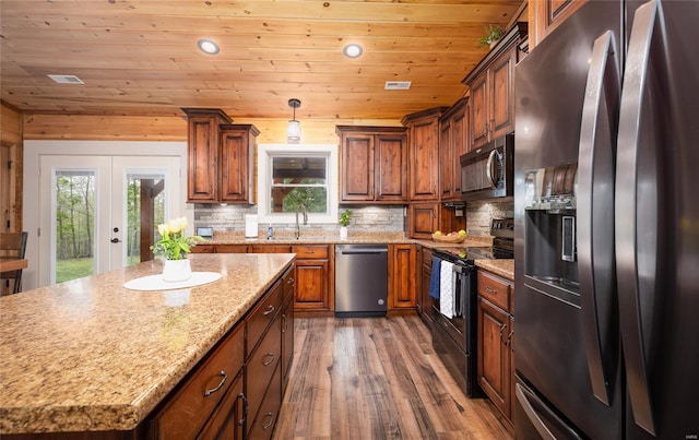 kitchen featuring tasteful backsplash, wood finished floors, appliances with stainless steel finishes, and wood ceiling