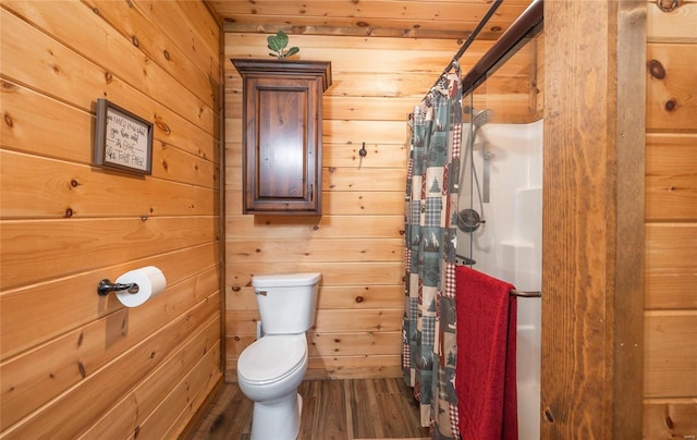 full bathroom with wood finished floors, toilet, wood walls, and a shower with curtain