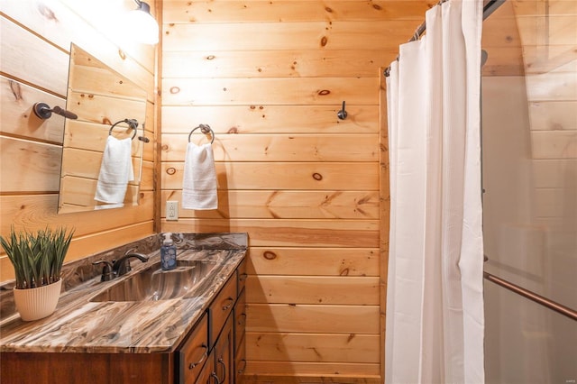 full bath with a shower with shower curtain, wooden walls, and vanity