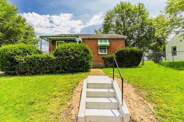 bungalow-style house featuring a front yard