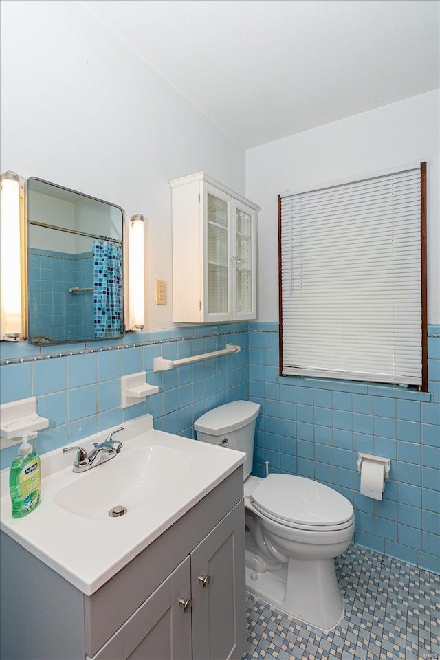 bathroom featuring tile patterned flooring, tile walls, vanity, a shower with curtain, and toilet