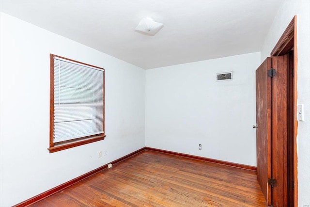 unfurnished room featuring dark wood-type flooring