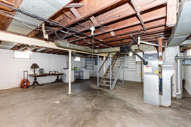 basement with heating unit and independent washer and dryer