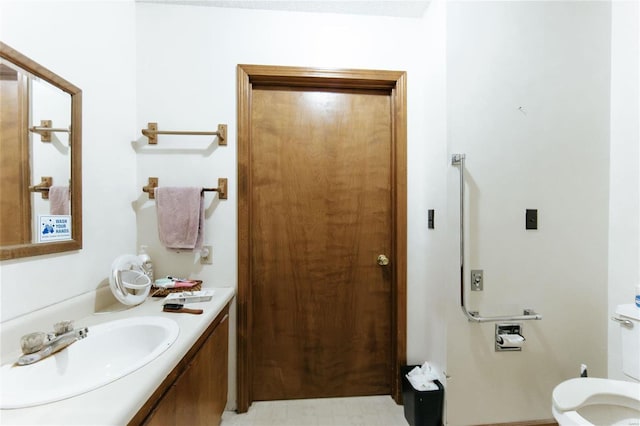 bathroom featuring tile patterned flooring, toilet, and vanity