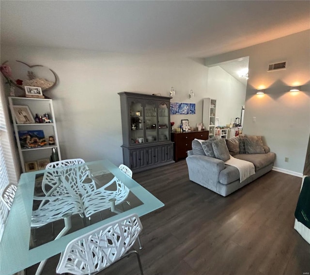 living room with dark wood-type flooring and vaulted ceiling