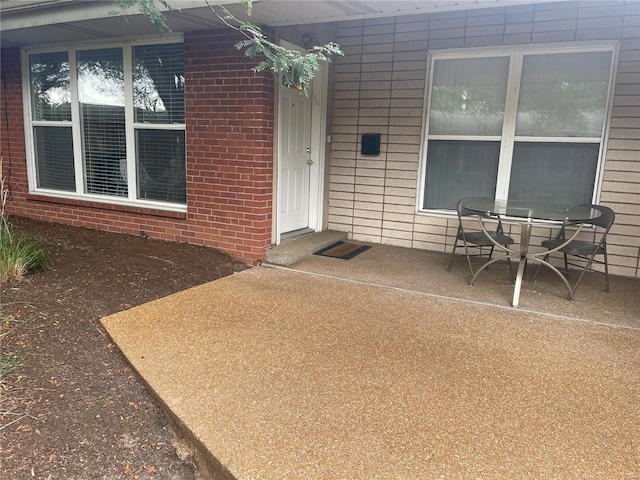 view of exterior entry featuring a patio