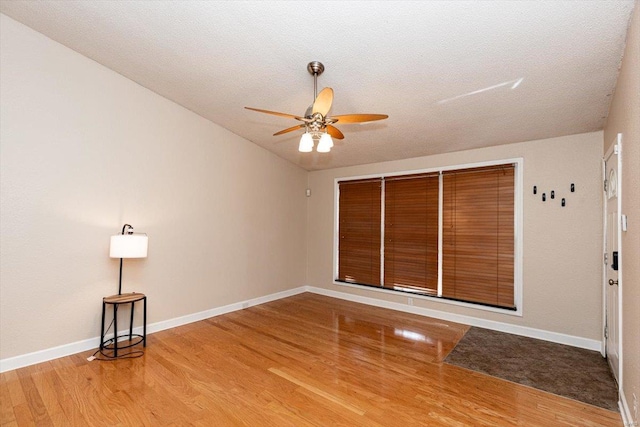 empty room with light hardwood / wood-style floors and ceiling fan