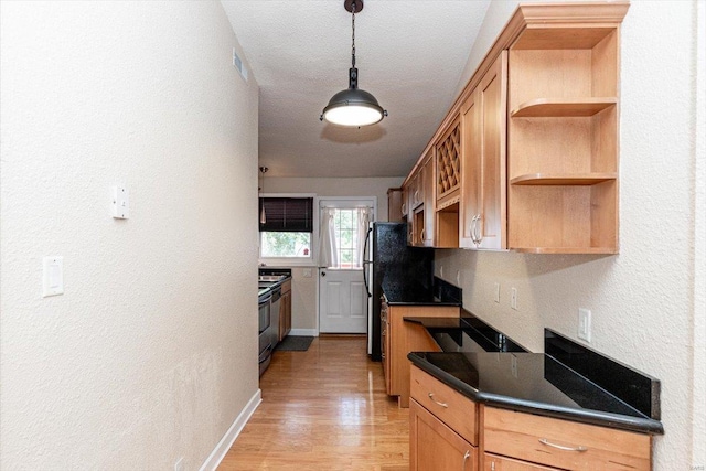 kitchen featuring light hardwood / wood-style floors, black refrigerator, range, and decorative light fixtures