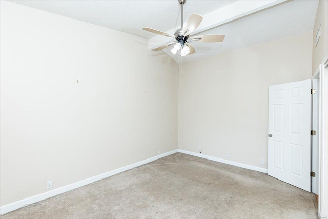 empty room featuring high vaulted ceiling, ceiling fan, and light colored carpet