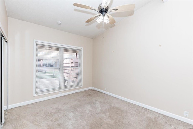 unfurnished room featuring ceiling fan and light colored carpet