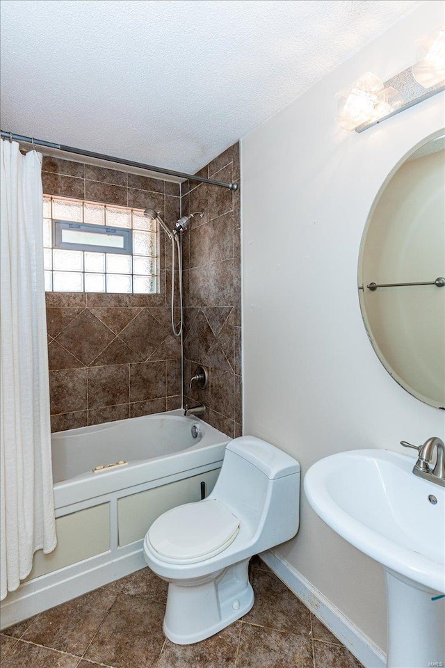 full bathroom with tile patterned floors, a textured ceiling, shower / bath combo, and toilet