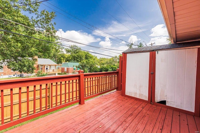 wooden deck featuring a storage unit