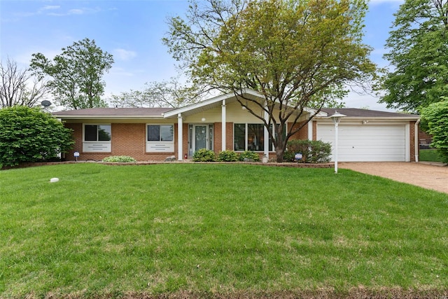 ranch-style house with an attached garage, concrete driveway, a front yard, and brick siding