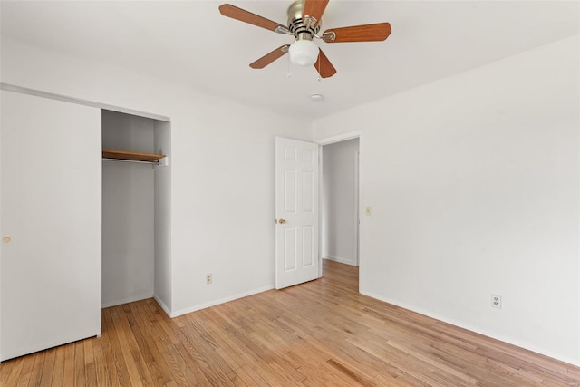 unfurnished bedroom featuring light wood-style floors, baseboards, ceiling fan, and a closet