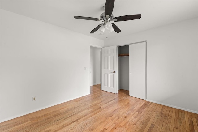 unfurnished bedroom with baseboards, ceiling fan, a closet, and light wood-style flooring