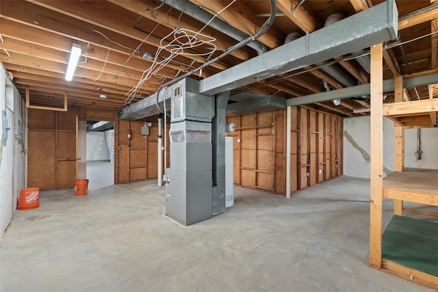 unfinished basement featuring heating unit