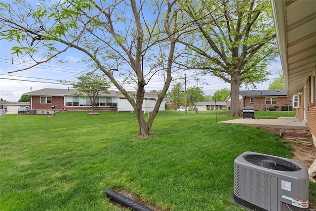 view of yard featuring a patio area and central AC