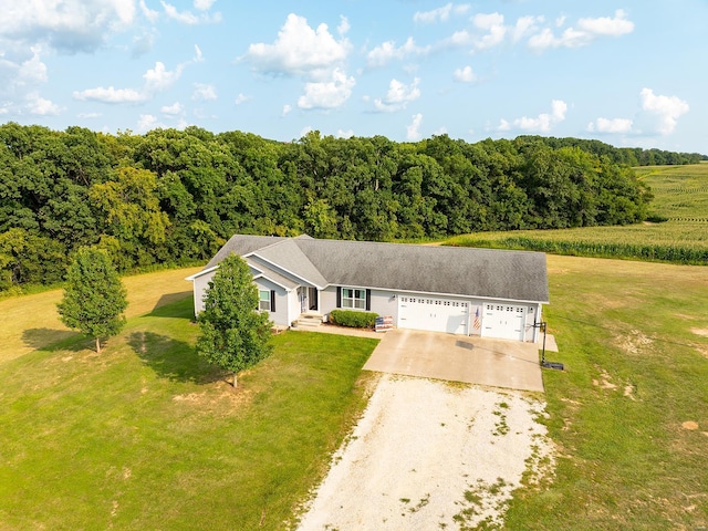 view of front of house featuring a garage, a front yard, and driveway