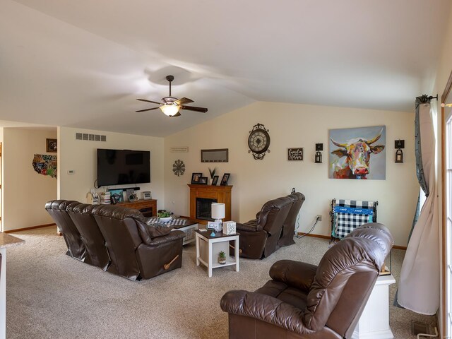 living room with vaulted ceiling, ceiling fan, and carpet flooring