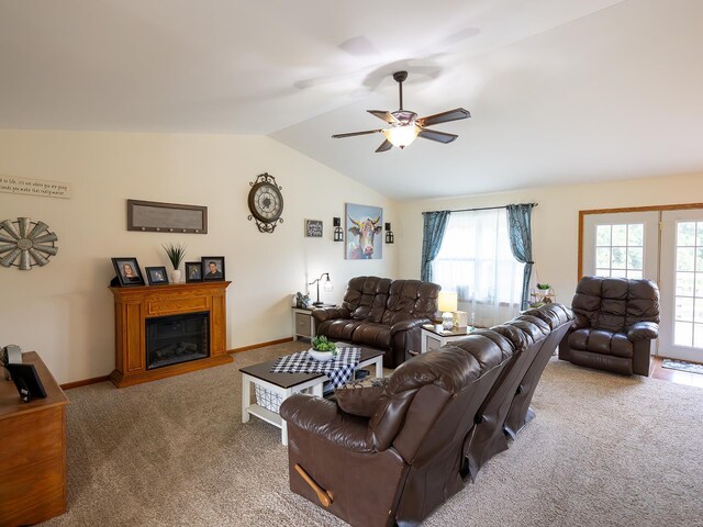 carpeted living room featuring vaulted ceiling and ceiling fan