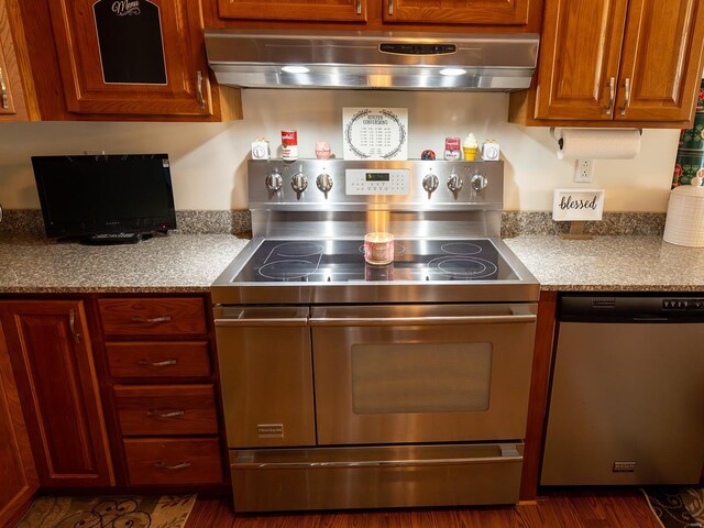 kitchen featuring stainless steel dishwasher, dark hardwood / wood-style floors, wall chimney exhaust hood, and range with electric stovetop