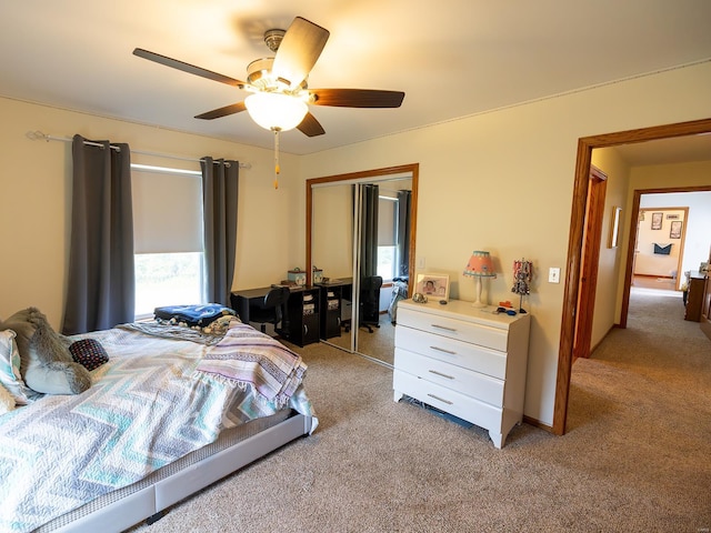 bedroom featuring ceiling fan, a closet, and light colored carpet