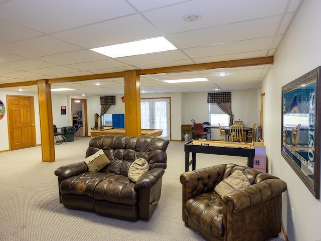 carpeted living room with french doors and a paneled ceiling