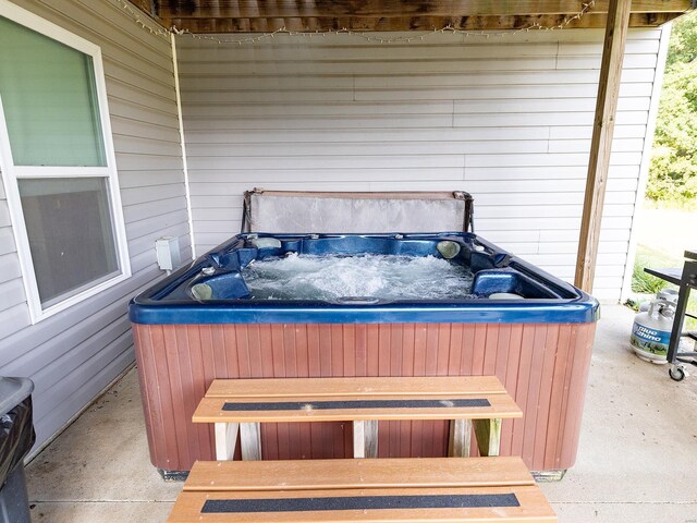 view of patio / terrace with a hot tub