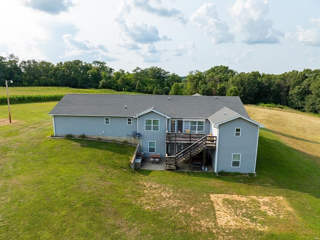 rear view of house featuring a yard, a deck, and a patio area