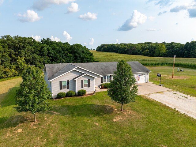 ranch-style home featuring a garage and a front lawn