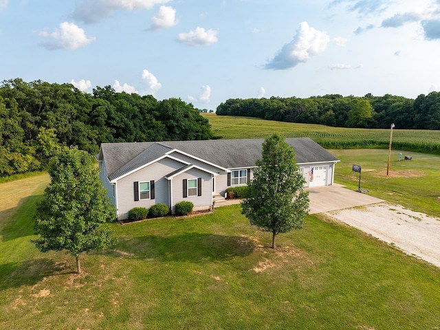 ranch-style home with an attached garage, driveway, and a front lawn