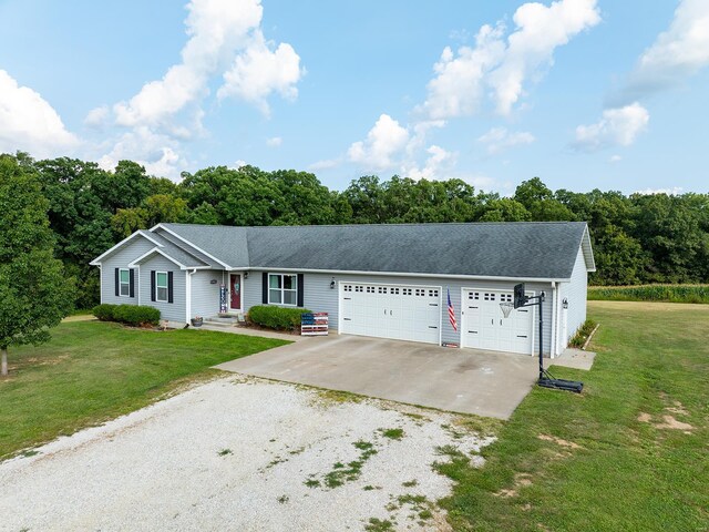 ranch-style home with a garage and a front yard