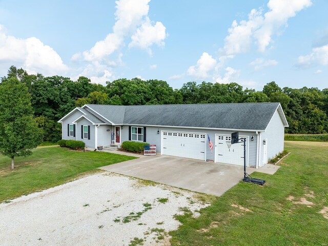 single story home with a garage and a front yard