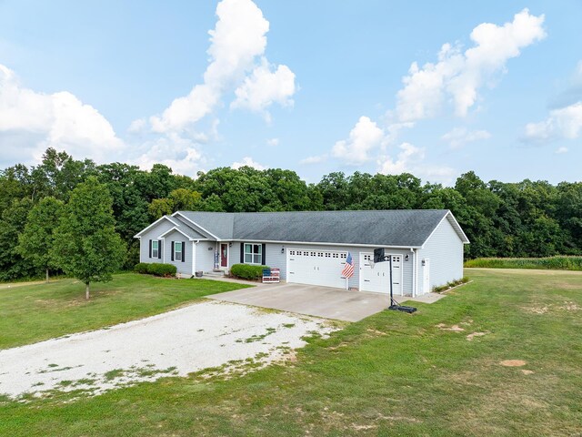 view of front of home featuring a garage and a front yard