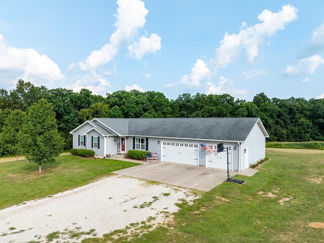 single story home featuring a garage and a front yard