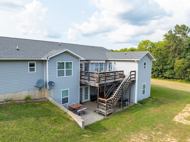 back of house featuring french doors, roof with shingles, a lawn, a wooden deck, and stairway