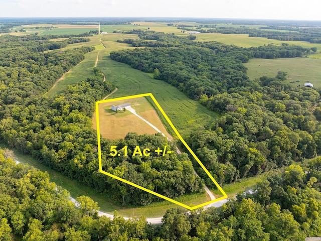 birds eye view of property with a rural view