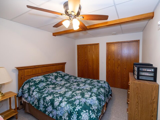 carpeted bedroom with multiple closets and ceiling fan