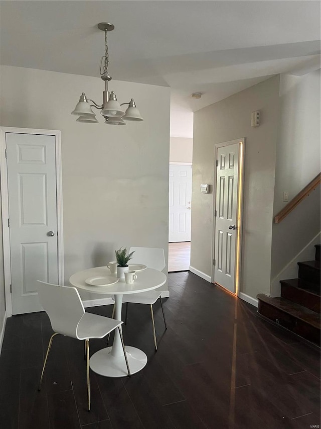 dining area with a chandelier and dark hardwood / wood-style flooring