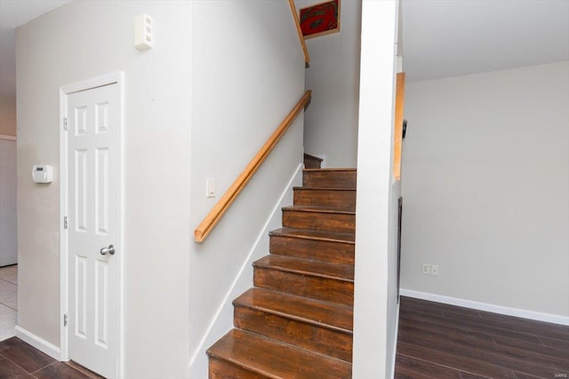 staircase featuring wood-type flooring