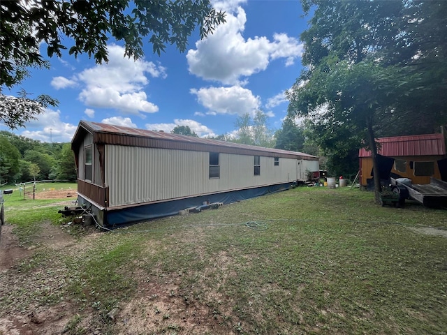 rear view of property with a lawn
