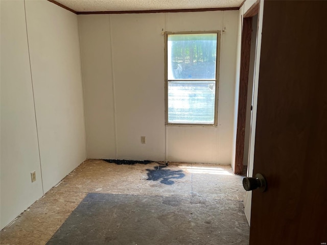 unfurnished room featuring a textured ceiling