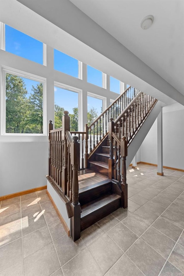 staircase featuring tile patterned floors