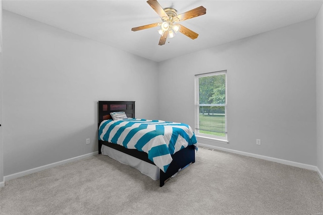 bedroom featuring light colored carpet and ceiling fan